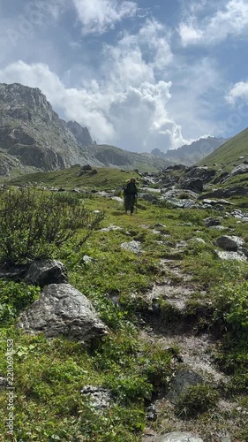Hiking in Tian Shan Mountains of Kyrgyzstan with rocky terrain and cloudy sky