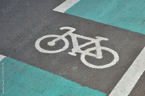 White bicycle symbol painted on asphalt cycle lane road surface
