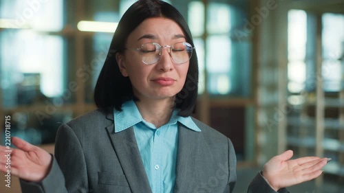 Portrait doubtful Asian business woman thinking shrug shoulders spreading hands unsure reaction looking at camera Korean female Chinese businesswoman Japanese architect think showing uncertain gesture