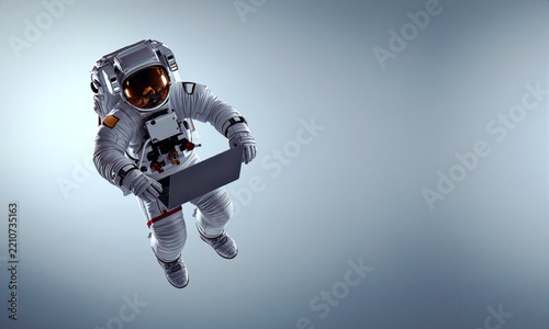 Futuristic astronaut working on a laptop while floating in zero gravity