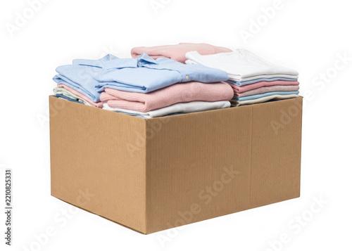 Cardboard box full of folded clothes isolated on transparent background