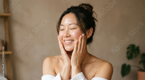 Beautiful young woman with clean, perfect skin. Portrait of a beauty model with natural nude makeup touching her face. Spa, skincare, and wellness. Close-up, copy space. 