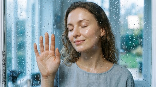 Beautiful young woman with clean, perfect skin. Portrait of a beauty model with natural nude makeup touching her face. Spa, skincare, and wellness. Close-up, copy space. 