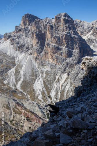 Rugged alpine mountain peaks with steep scree slopes and bird