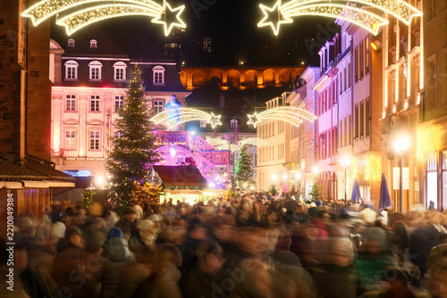 Obraz na plátně Loads of people with motion blur at a Christmas fare in the historic German city of Heidelberg