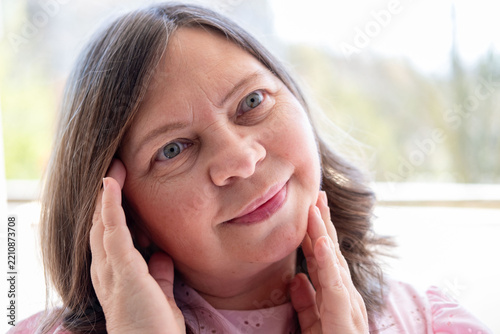 Fotografie close-up view facial skin, woman examines her fat neck, saggy chin with visible