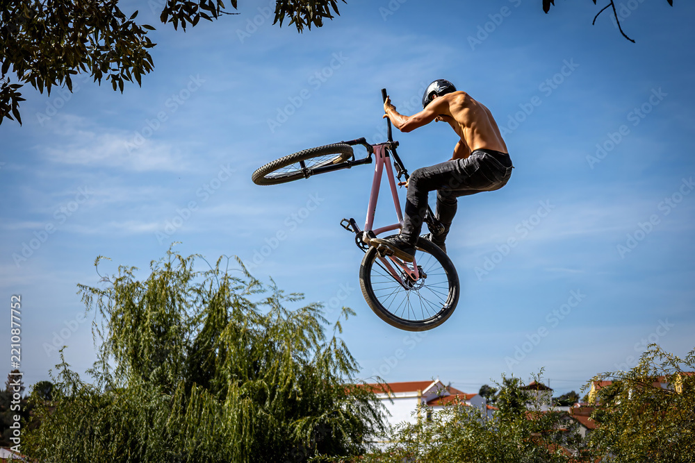 Obraz premium Dirt bike rider jumping on a dirt track in Arripiado village by the Tagus River, Portugal