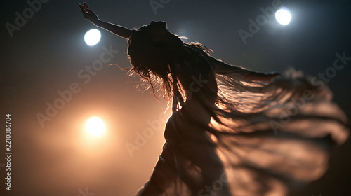 Silhouette of Graceful Female Dancer Performing on Stage