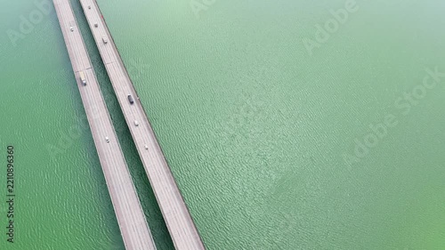 Aerial Reveal of Highway Bridge and Reservoir surrounded by Dense Forest