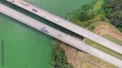 Aerial Reveal of Highway Bridge and Reservoir surrounded by Dense Forest