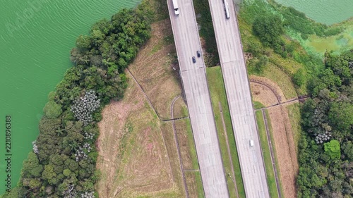 Aerial Reveal of Highway Bridge and Reservoir surrounded by Dense Forest