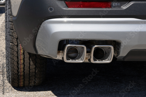Performance exhaust pipes with square tips. Closeup of exhaust pipes from a car muffler.