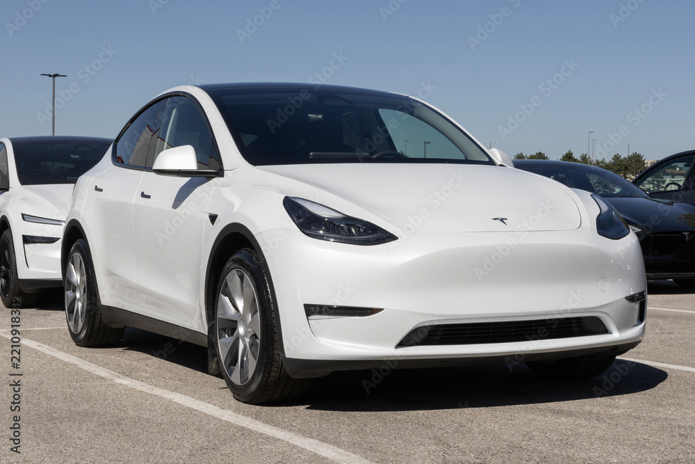 Naklejka premium Used Tesla Model Y SUV display. With pricing concerns, Tesla is buying and selling used vehicles to meet demand. MY:2023