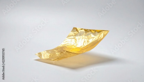 Gold Translucent Sheet Floating on Clean White Studio Background