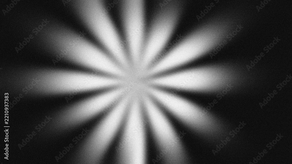 Fototapeta premium Abstract retro radial sunburst with monochrome grain texture. Dark starburst background, glowing light rays, vintage cinematic overlay.