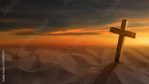 A wooden cross stands on a dark surface against a warm, glowing sunset sky, symbolizing faith, religion, and spirituality with copy space. Christian background