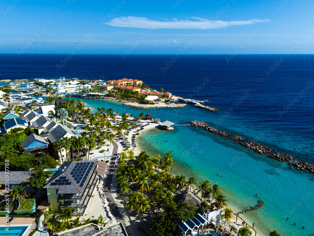 Fototapeta premium Mambo Beach with turquoise water, palm trees and white sand in Curacao, Caribbean