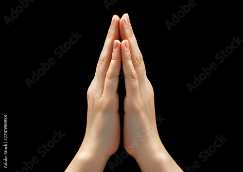 Close-up of hands praying isolated on black background, faith, hope, spirituality.

