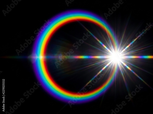 Rainbow lens flare circular optical effect glowing on dark background with bright starburst light