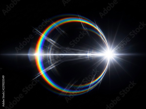 Abstract lens flare light effect with glowing rainbow rings and bright starburst on black background