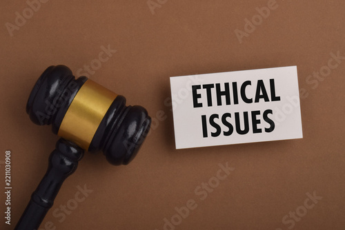 Legal gavel beside an ethical issues sign, representing law, justice, professional ethics, moral dilemmas, legal responsibility, and decision making.