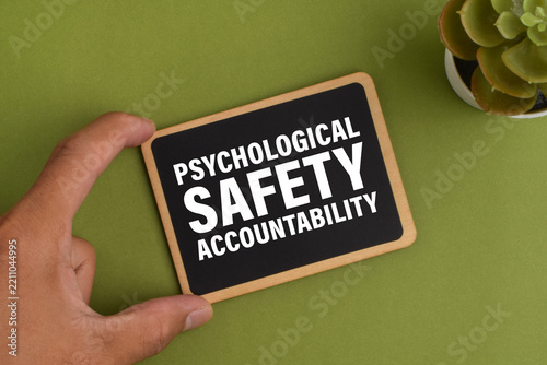 Wooden sign showing psychological safety and accountability, representing workplace trust, employee wellbeing, respectful culture, responsibility, communication, and organizational support.