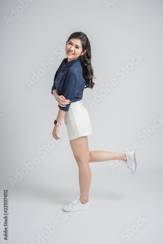 Happy Asian Woman in Casual Outfit Posing in White Sneakers