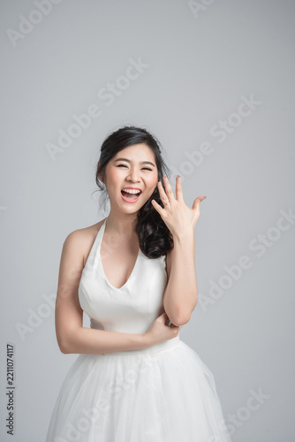Happy Asian Woman Wearing White Dress Showing Engagement Ring