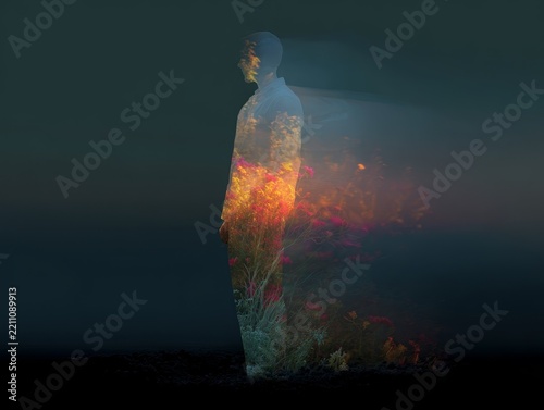 Silhouette figure with floral fire double exposure standing in profile for spiritual background and shamanic concept