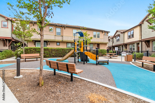 Playground in private community, landscaped garden beds. recreational facilities in a residential neighborhood