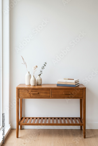 Scandinavian minimalist entryway with wooden console table and white vases