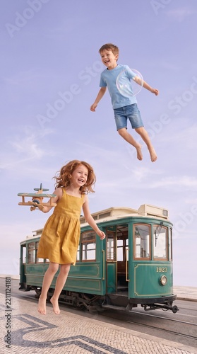 Surreal photomontage of children floating beside a vintage tram