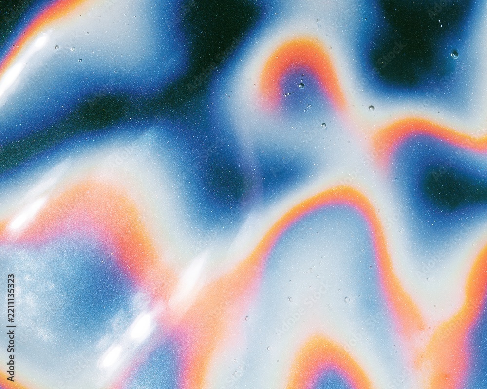 Fototapeta premium Holographic mirror glaze surface with a wet iridescent sheen and rainbow ripples for confectionery packaging and pop culture backgrounds