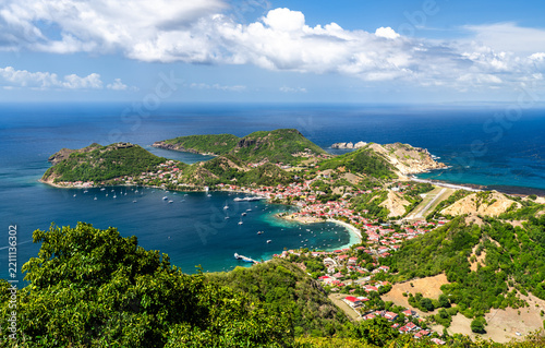 Panoramic aerial view over the bay, village, and green hills of Terre-de-Haut island in Les Saintes, Guadeloupe.