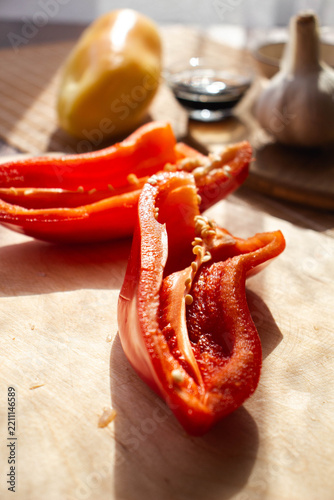 Fresh Red Bell Pepper on Wooden Cutting Board with Garlic and Soy Sauce