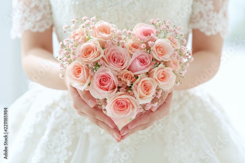 結婚式を彩る美しいピンクのハートブーケを花嫁が優しく抱きしめる