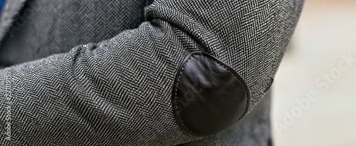 Captures Close View Of Persons Arm Focusing On Elbow Area Main Subject Wearing Herringbone Patterned Suit Jacket Primarily Black White