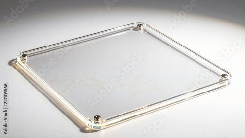 Empty clear acrylic picture frame with metal spacers