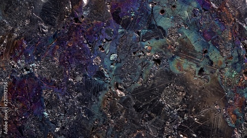 Iridescent bornite mineral texture, close-up view of metallic sulfide ore with tarnish colors