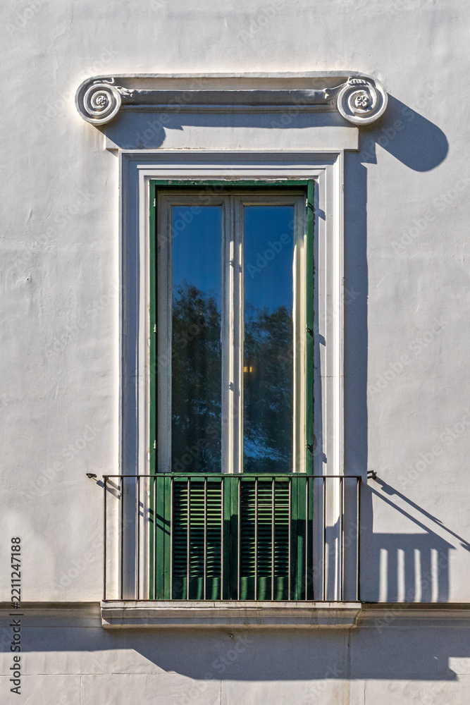 Obraz premium Classic European Architecture Detail Showcasing Green Shutters and Wrought Iron Railing