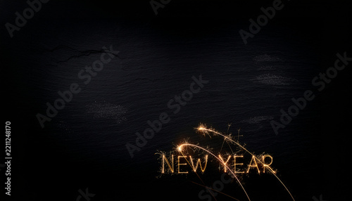 New year sparkler lettering on dark background celebrating holiday
