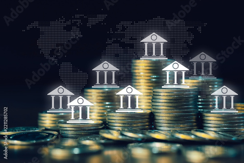 Golden coin stacks with multiple bank icons and world map visualize global financial systems, international banking networks, investment capital, monetary services, and economic connectivity.