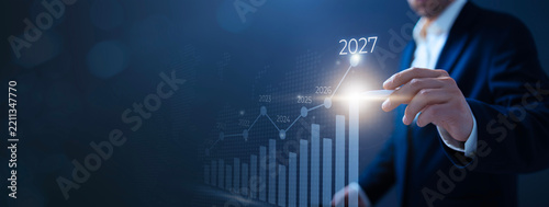 Businessman Touching 2027 Financial Growth Graph with Stylus Banner