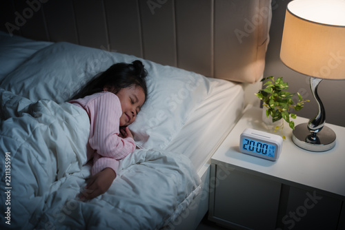 preschool child girl sleeping on bed and sweet dream at night