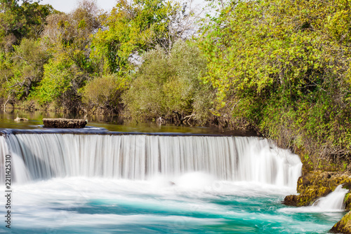 wide waterfall on river, blurred movement of water, long exposure
