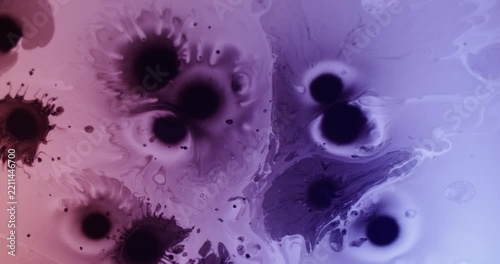 Paint blot. Spreading ink. Defocused purple blue pink color pigment droplet water texture floating on abstract neon acrylic background.