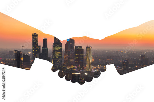 Silhouette of handshake with city panorama with skyscrapers during sunset, collage