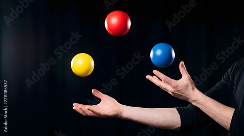 Juggling primary color spheres midair, skilled entertainer performing balance concept, hands juggling red blue yellow balls against dark background