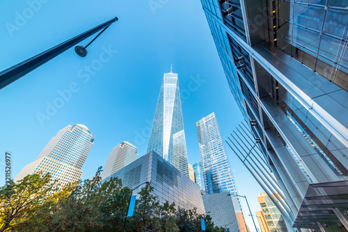 Modern skyscrapers in Lower Manhattan under a blue sky viewed from below