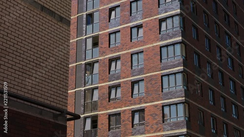 Exterior brick facade of modern multistory residential apartment building